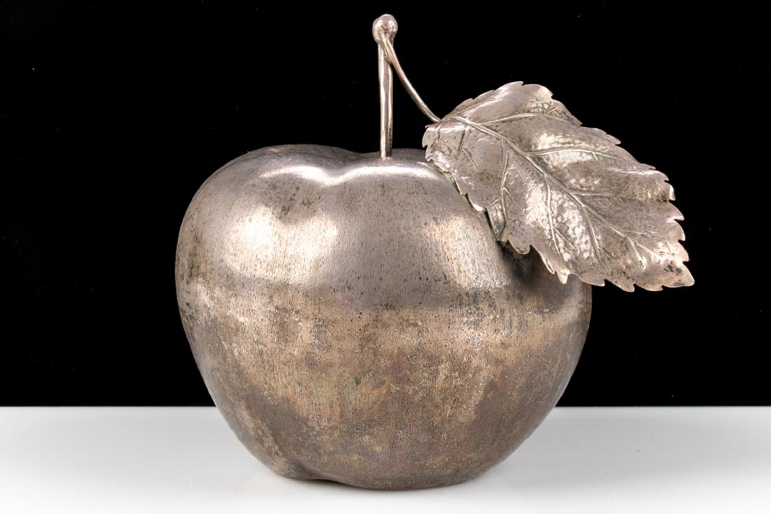 Mario Buccellati Sterling Silver Apple Form Lighter: Marked 925 with name on the base. A sterling silver apple with a leaf on the stem and a hollow base with the lighter attached. H. 4 1/2", W. 3 5/8", hollow base Diam. 2 1/8" tarnished, three small din
