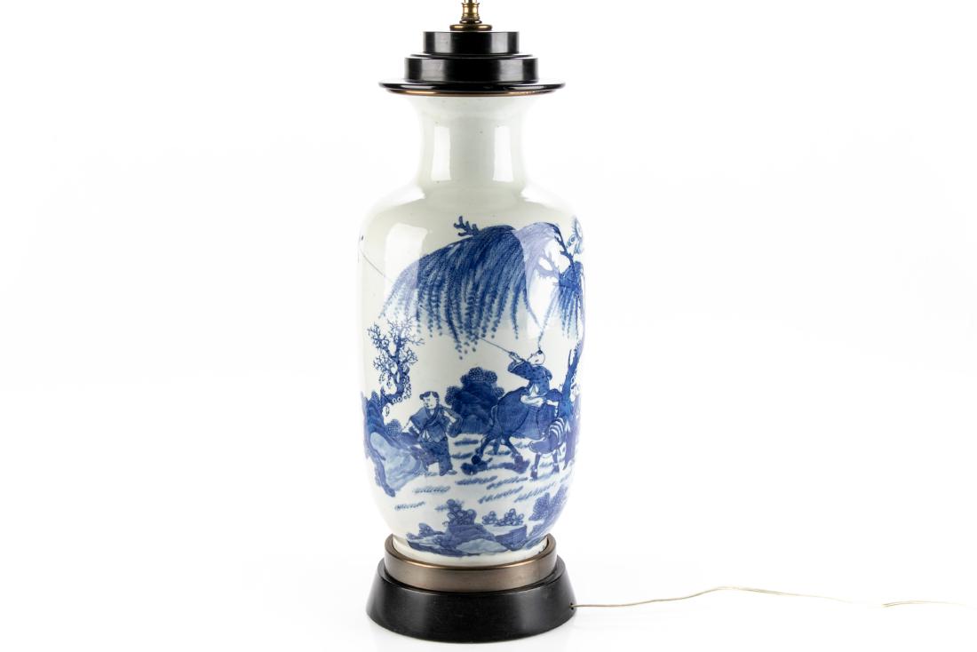 Chinese Blue & White Vase Mounted As A Lamp: A large Chinese blue and white porcelain vase mounted as a lamp with figural landscape, three figures beneath a weeping cherry tree, one figure atop an animal, possibly an ox, flying a butterfly form 