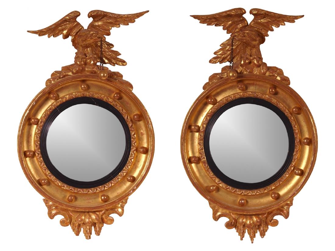 Pair 19th c Carved Wood, Gilt And Gesso Convex Mirrors: Pair of opposing eagle crest carved wood, gilt and gesso diminutive convex wall mirrors. The eagles are holding balls suspended from fine chains mounted on top of a convex mirror with bead trim border