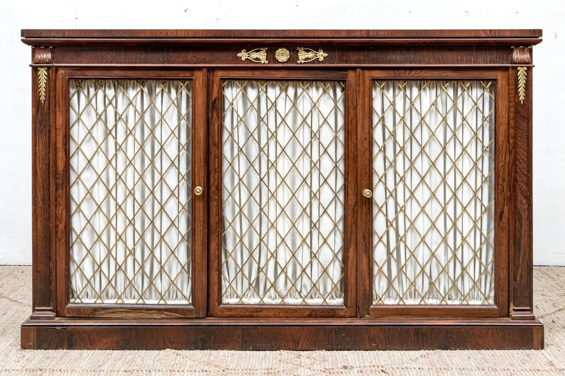 Handsome William IV Sideboard: A handsome William IV style sideboard carved and veneered in rich, warm-toned medium brown wood with a stately rectangular profile accentuated by columnar front corners with flourished foliate capital