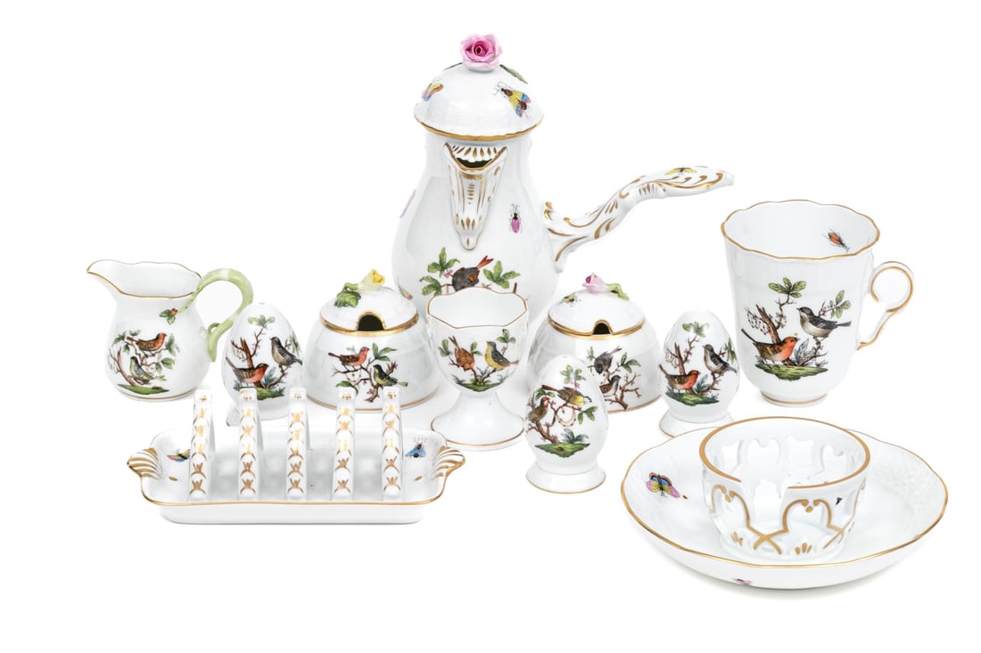Eleven Piece Herend Porcelain Serving Lot: A wonderful collection of Herend Rothschild Bird porcelain serving pieces. Comprised of a lidded chocolate pot, two lidded sugars, three egg form casters, one egg cup, one creamer, a saucer plate with