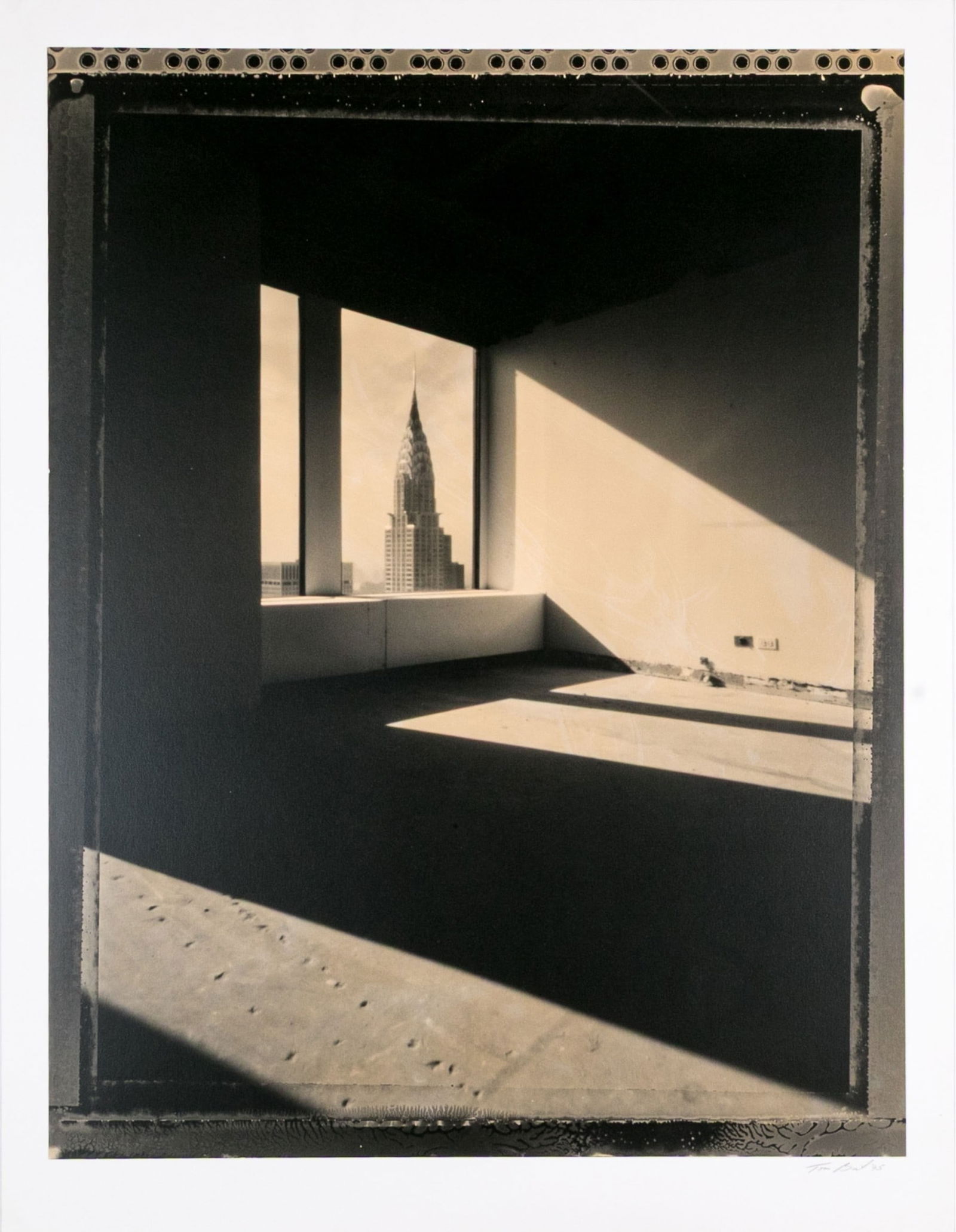 Tom Baril (American, B. 1952) "Chrysler Build" Signed Gelatin Silver Print: Tom Baril (American, B. 1952) "Chrysler Build" Gelatin silver print depicting a view of the Empire State Building from a brutalist interior with high contrast from the light and shadows created by the