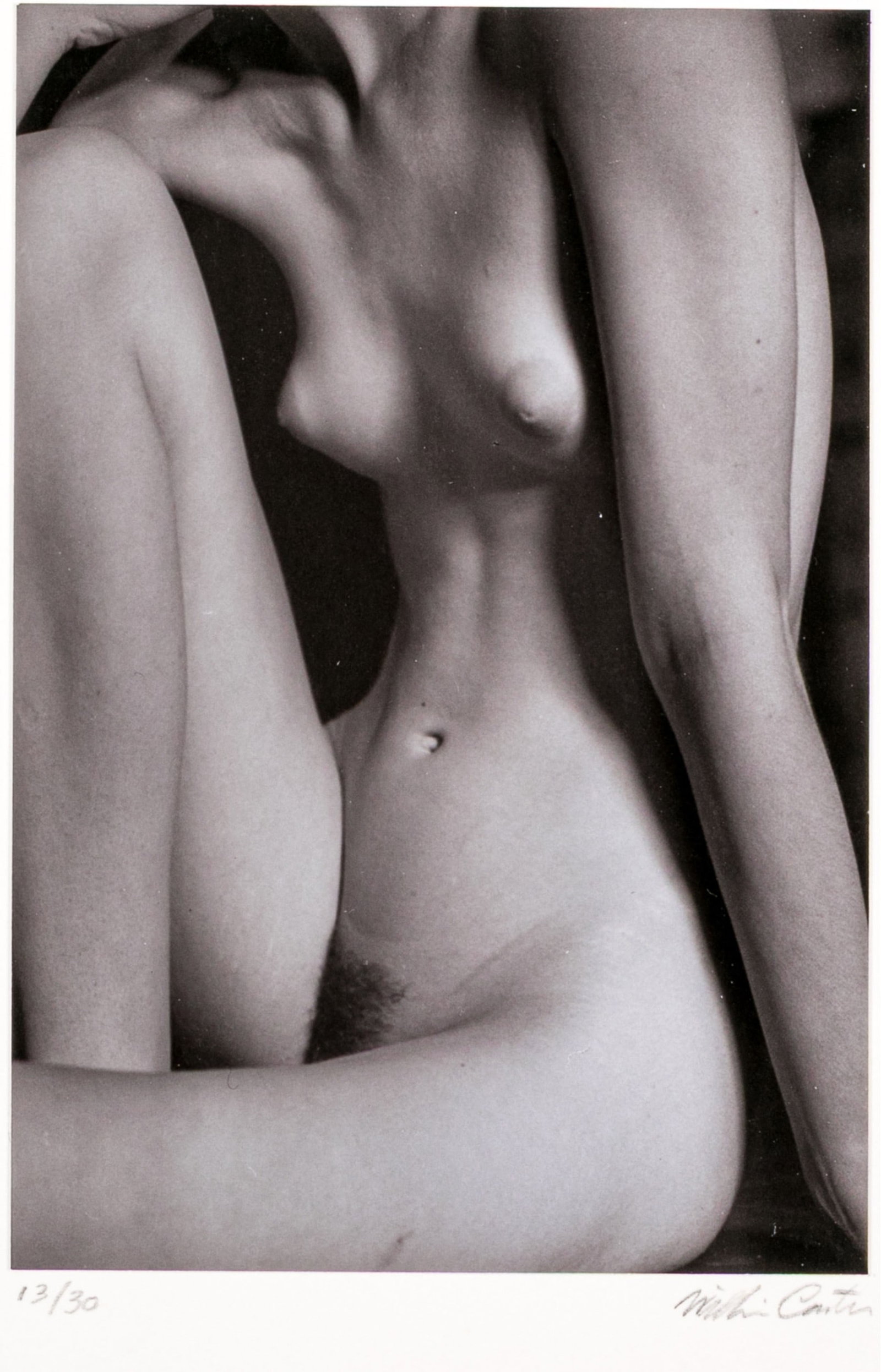 William Carter (American, 1934-2025) "Willow (1984)" Ltd. Ed. Gelatin Silver Print: William Carter (American, 1934-2025) "Willow (1984)" gelatin silver print mounted on board depicting a female nude posed sitting with back hunched and one knee pulled towards the chest against a dark 