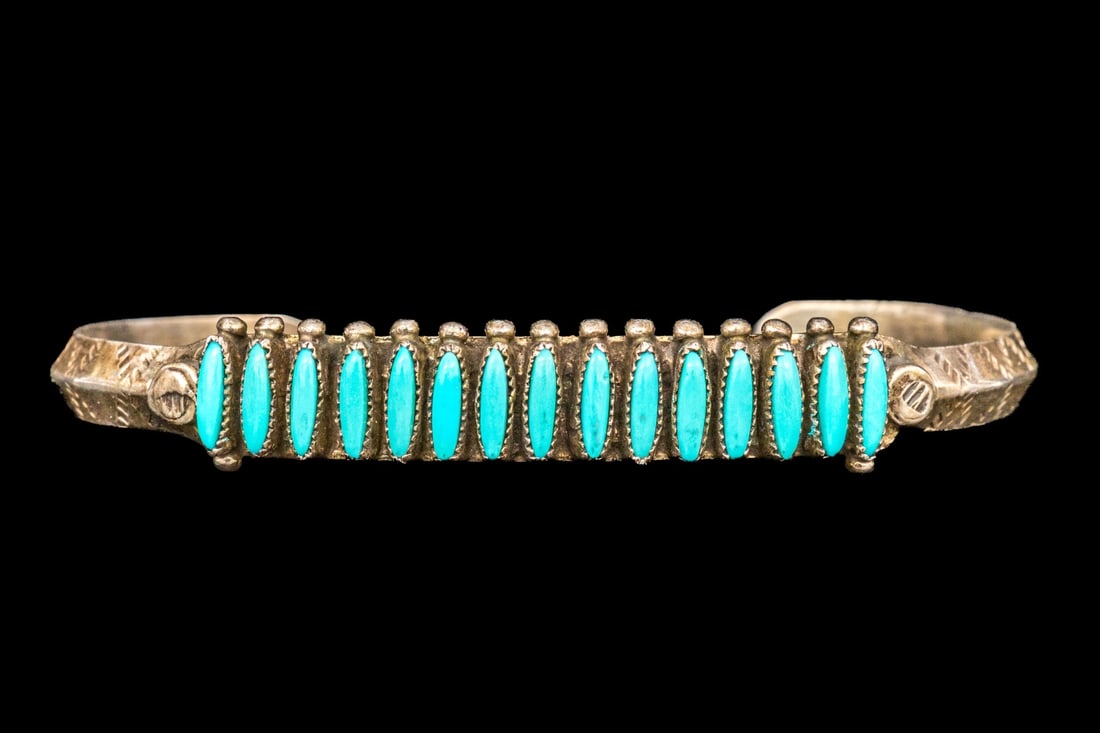 ZUNI JANICE PALOMA STERLING SILVER NEEDLEPOINT TURQUOISE CUFF BRACELET: This handsome sterling silver Zuni cuff bracelet by Janice Paloma features a needlepoint turquoise set top, finished with chased knife edged shoulders. "Needlepoint in Zuni silversmithing is a highly 