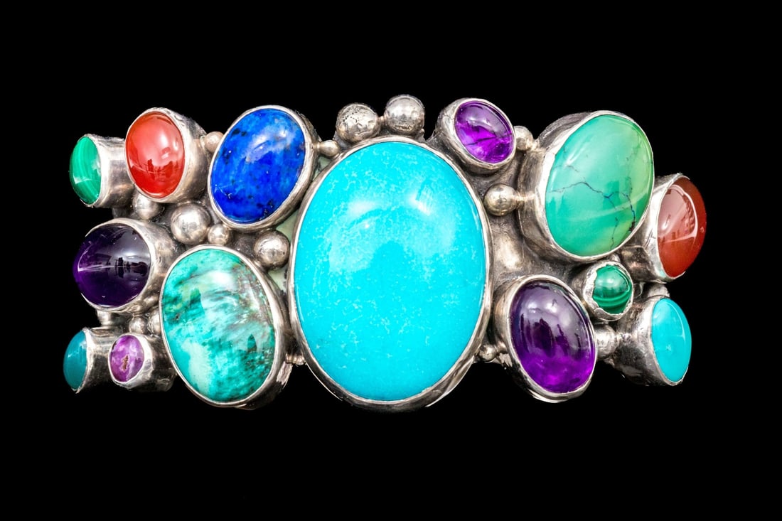 NAVAJO GRACE AND GILO NAKAI STERLING SILVER GORGEOUS MULTI-STONE CUFF BRACELET: This gorgeous sterling silver Navajo cuff bracelet by Grace and Gilo Nakai features a myriad of bezel set cabachon stones, including amethysts, malachites, carnelians, and lapis, interspersed with a b