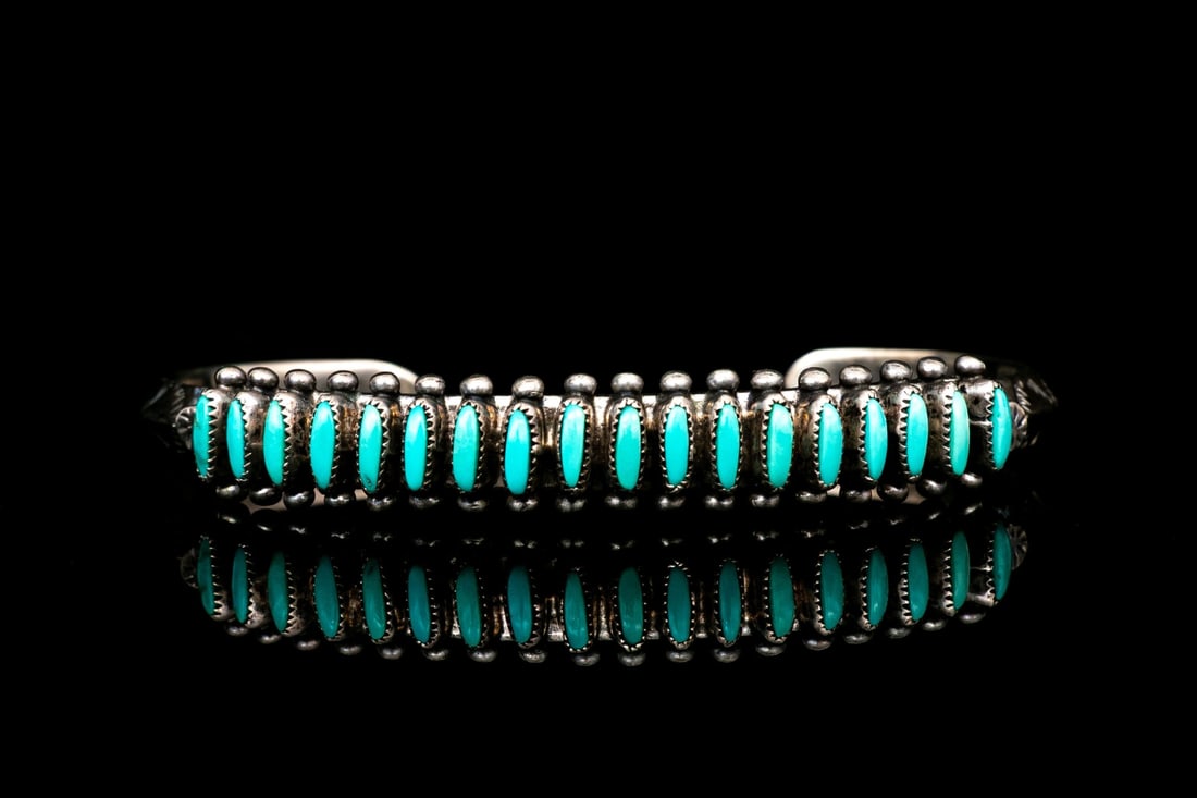 ZUNI PORFILIO SHEYKA STERLING SILVER NEEDLEPOINT TURQUOISE CUFF BRACELET: This beautiful Zuni sterling silver cuff bracelet is by Porfilio Sheyka, and features a row of navette form turquoise stones, arrayed in a row with prong set beaded ends, and finished with chased, pat