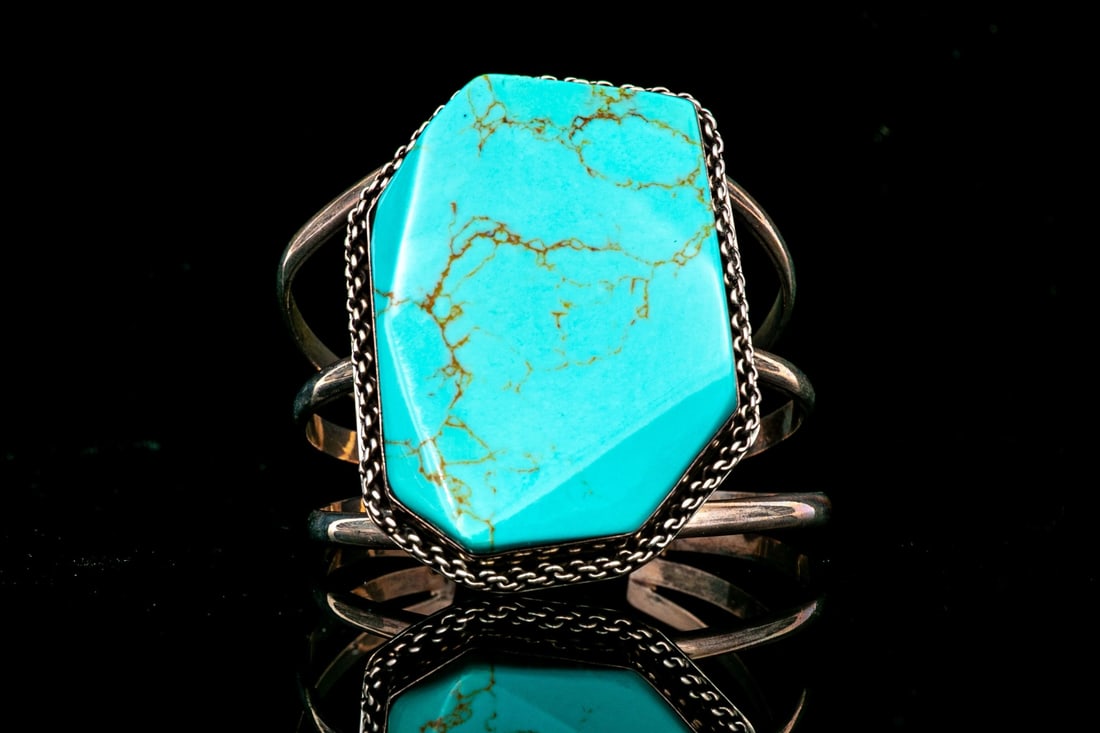 STERLING SILVER STUPENDOUS ULTRA WIDE ANGLED TURQUOISE CUFF BRACELET: This stupendous sterling silver cuff bracelet features a large, angled turquoise center, bezel set and adorned with a rope frame, and triple, open shoulders Marks: Mexico Dimensions: 2 1/8" interior d