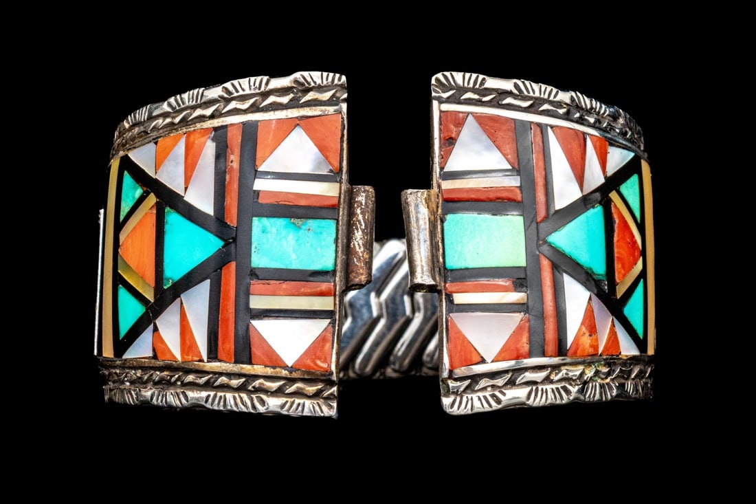 ZUNI JOHN AND ROSALIE BOWANNIE STERLING SILVER STRIKING ARROW PATTERN INLAID WATCH TIPS: Zuni John and Rosalie Bowannie sterling silver striking arrow pattern inlaid watch tips, set with mother-of-pearl, onyx, turquoise and carnelian, and finished with a steel expansion band. "John and Ro