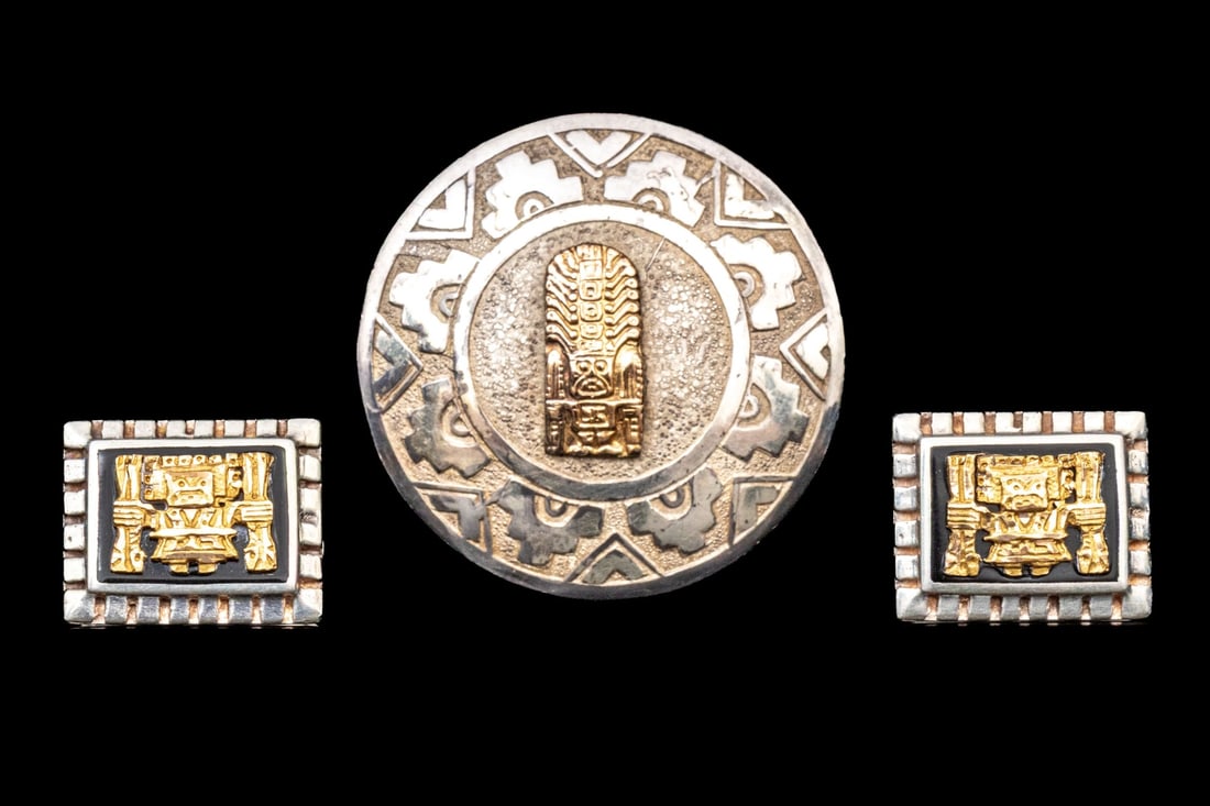 PAIR OF STERLING SILVER AND GOLD AZTEC INSPIRED JEWELRY PIECES: This complementary pair of jewelry pieces feature a sterling silver brooch/pendant with an etched, Aztec inspired patterning, finished with an 18k yellow gold icon motif center, paired with a pair of 