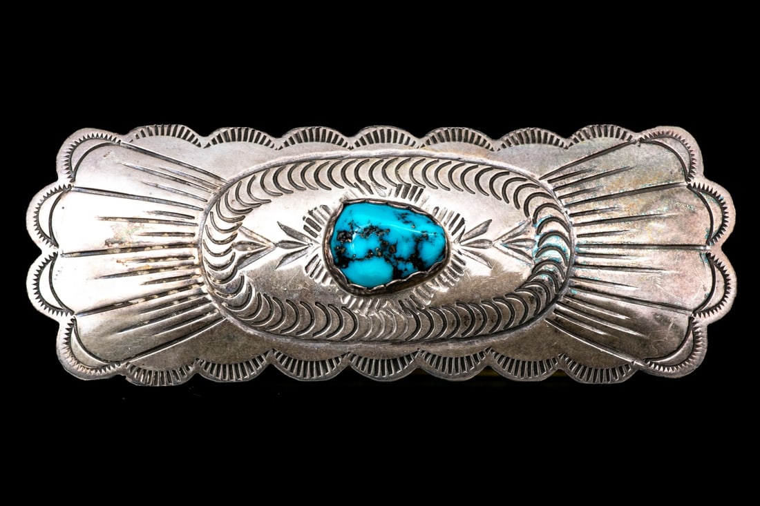 NAVAJO SPENCER STERLING SILVER CHASED AND TURQUOISE SET BROOCH: This classic Navajo sterling silver brooch features a rectangular profile, with scalloped edges and a tumbled turquoise center, and finished with a chased, patterned body Marks: Sterling, Spencer Dime