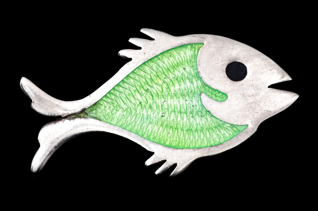 SOUTHWESTERN STERLING SILVER CHARMING GREEN ENAMEL FISH MOTIF BROOCH: This sterling silver Southwestern style brooch is a charming fish motif, decorated with a light green enamel guilloche patterning, and finished with a black enamel eye Marks: 925, Mexico Dimensions: 1