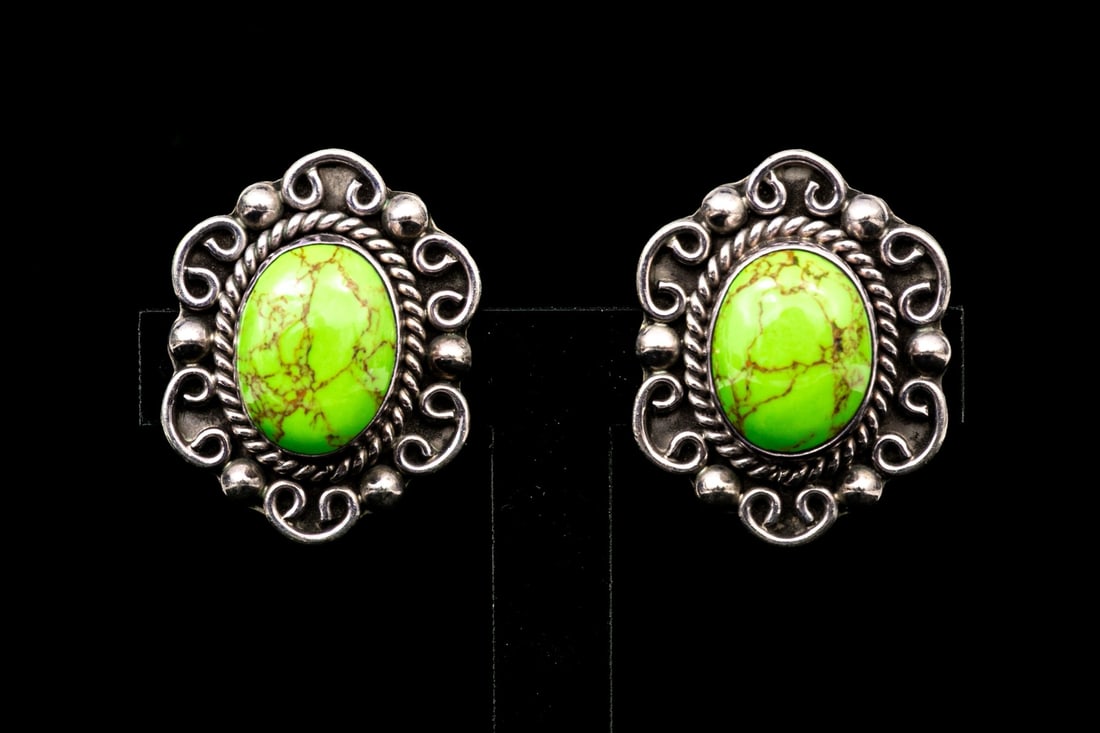 MEXICO STERLING SILVER CHUNKY COPPER TURQUOISE CABACHON EARRINGS: These eye-catching earrings feature an oval cabachon, bright green copper turquoise center, with a rope and decorative scrolled sterling silver border. Finished with clip on style backs. Please note: 