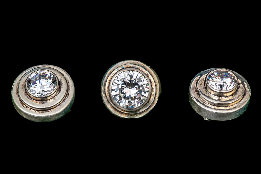 STERLING SILVER DAZZLING ROUND BRILLIANT CZ SET RING, SIZE 8, WITH MATCHING EARRINGS: This sterling silver dazzling large round brilliant CZ set ring features a bezel set center, atop a step cut plinth and finished with a high polish. Accompanied by matching earrings, finished with cli