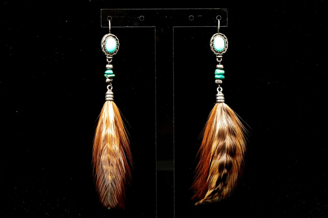 ULTRA-LONG SOUTHWESTERN STYLE GENUINE FEATHER DROP PENDANT EARRINGS: These striking Southwestern motif ultra long drop pendant earrings feature a turquoise cabachon top, a tumbled turquoise stack, which lead into a genuine brown toned feather. The earrings are