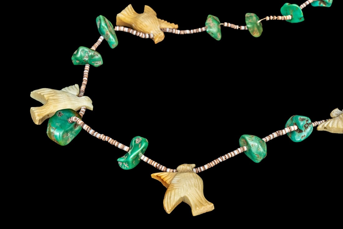 VINTAGE SOUTHWESTERN FETISH NECKLACE: The necklace is composed of turquoise stones strung with carved bone birds and tiny beads. 27" L
