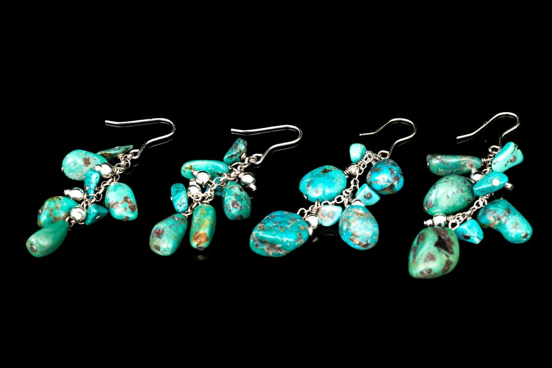 DUO OF STERLING SILVER TUMBLED TURQUOISE CLUSTER DROP PENDANT EARRINGS: This duo of drop pendant Southwestern style drop pendant earrings feature clusters of tumbled turquoise stones, and are finished with shepherd's style hooks Marks: 925, none Dimensions: 2 1/4" long