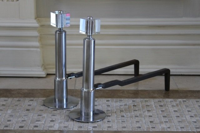PAIR OF MODERN ART DECO STYLE LUCITE ANDIRONS: Mid-century French chrome lucite andirons with iron log supports 14" h x 20" d Provenance: Purchased from Objects Plus Inc by Inson Dubois Wood for $1200.00