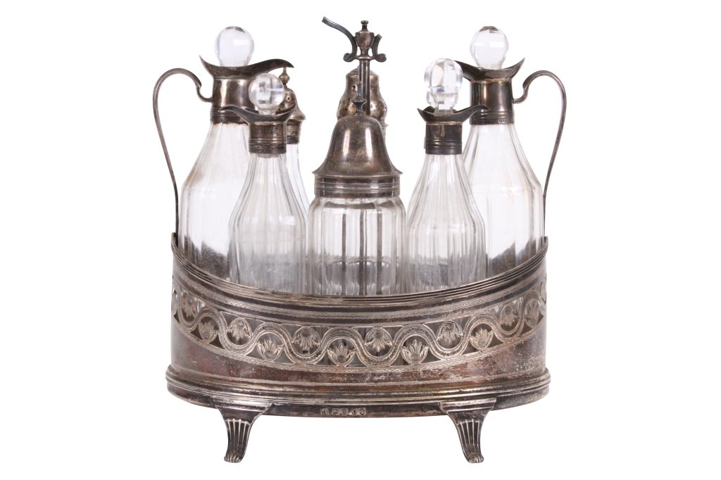 PETER & ANN BATEMAN 1798-99, GEORGE III CRUET SET: London, with pierced and floral engraving, fitted with eight bottles, 8" high x 7" long, carry handle broken, one small bottle replaced with a silver plated topped castor and large bottle with replace
