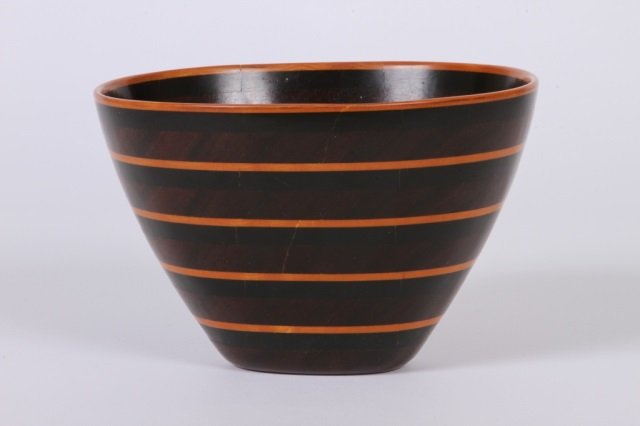 PETER PETROCHKO, 1982 MIXED WOODS BOWL: Maple, ebony and padauk woods initialed PMP measuring 4 3/4" high x 7 1/4" long x 6 1/2" wide.