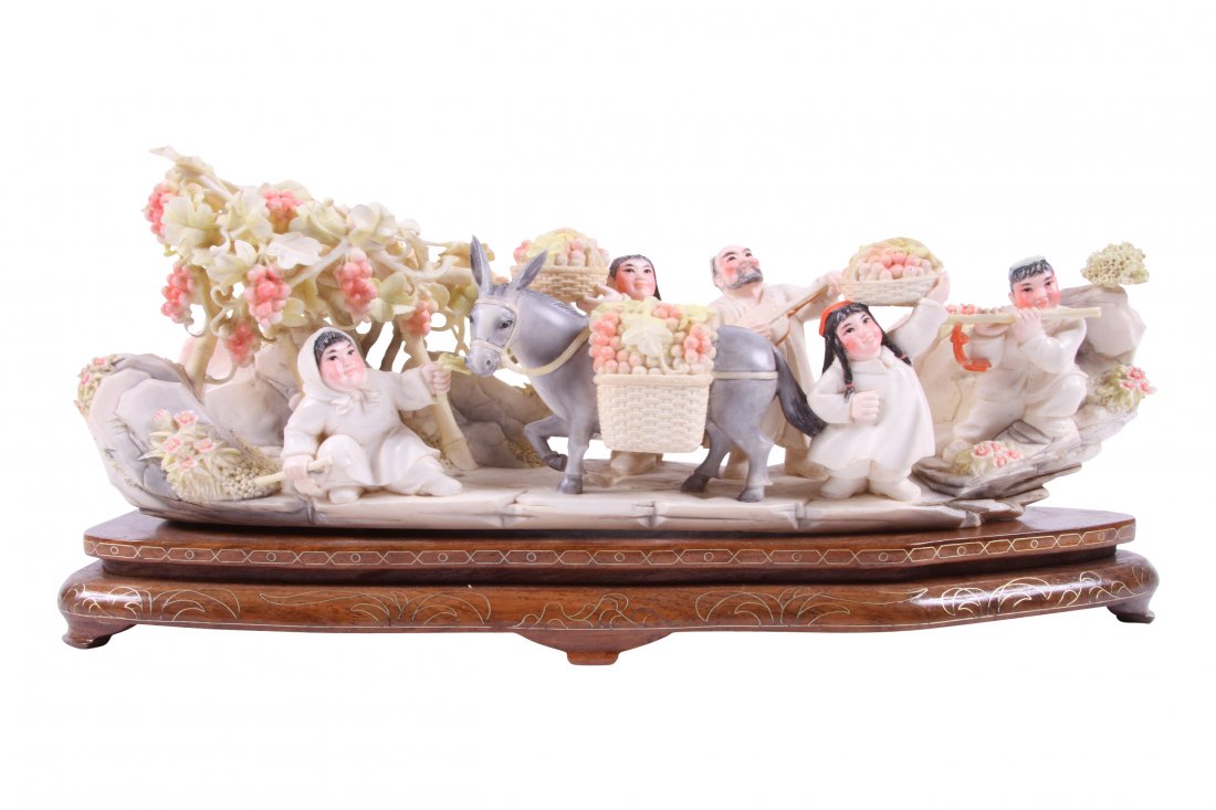 Contemporary Chinese Carved Ivory Figural Group "The: Contemporary Chinese Carved Ivory Figural Group "The Harvest" Stained ivory grapevines villagers and donkey on wood base. 13" x 3 3/4" x 4 1/2"