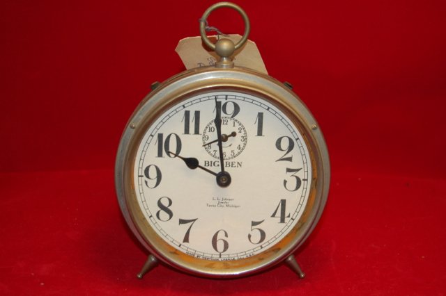 Vintage Big Ben Alarm Clock Personalized: This Big Ben Alarm clock has a white face which has been imprinted with the following: "L.L. Johnson Jeweler Tawas City, Michigan. Three screws on the front rim and square end on the rear support.