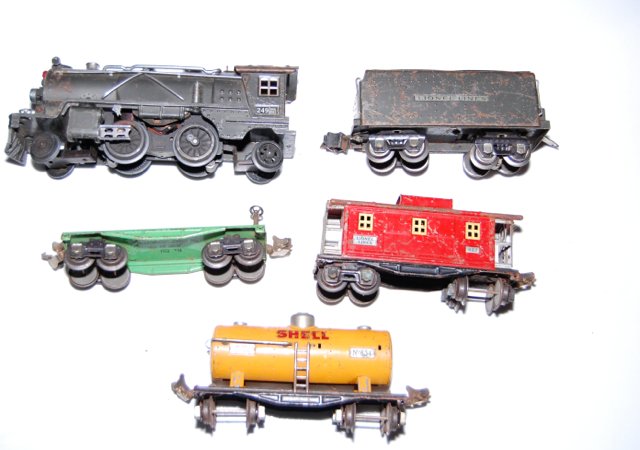 Pre-War Lionel Train Set 249 Engine: Pre-War Lionel trains with 249 engine. The engine is missing the side rods. Comes with coal tender, caboose and flat car. All pre-war couplers. Wheels on engine move when rolled.