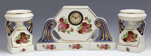 Three Piece China Clock Set: Three Piece China Clock Set, c. 1920, consisting of a mantel clock and two coupes, with gilt, cobalt, and floral transfer decoration, Clock- H.- 8 1/2 in., W.- 15 1/4 in., D.- 3 1/2 in.
