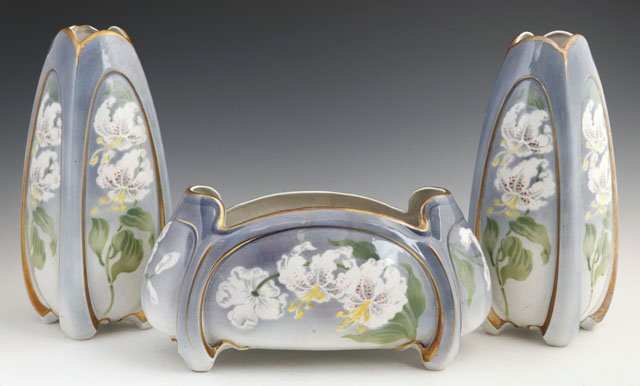 Three Piece Hamage Nord Porcelain Mantel Garniture: Three Piece Porcelain Mantel Garniture, 20th c., consisting of a planter and a pair of vases, all with floral decoration and gilt accents, Vases- H.- 11 1/4 in., W.- 4 1/2 in., D.- 4 1/2 in.