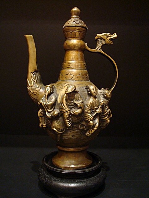 Antique Chinese bronze teapot seven immortals with mark: Antique Chinese bronze teapot seven immortals, with the 7 immortal body carved with archaistic decoration, handle with Dragon, marks on base, 7.00in.