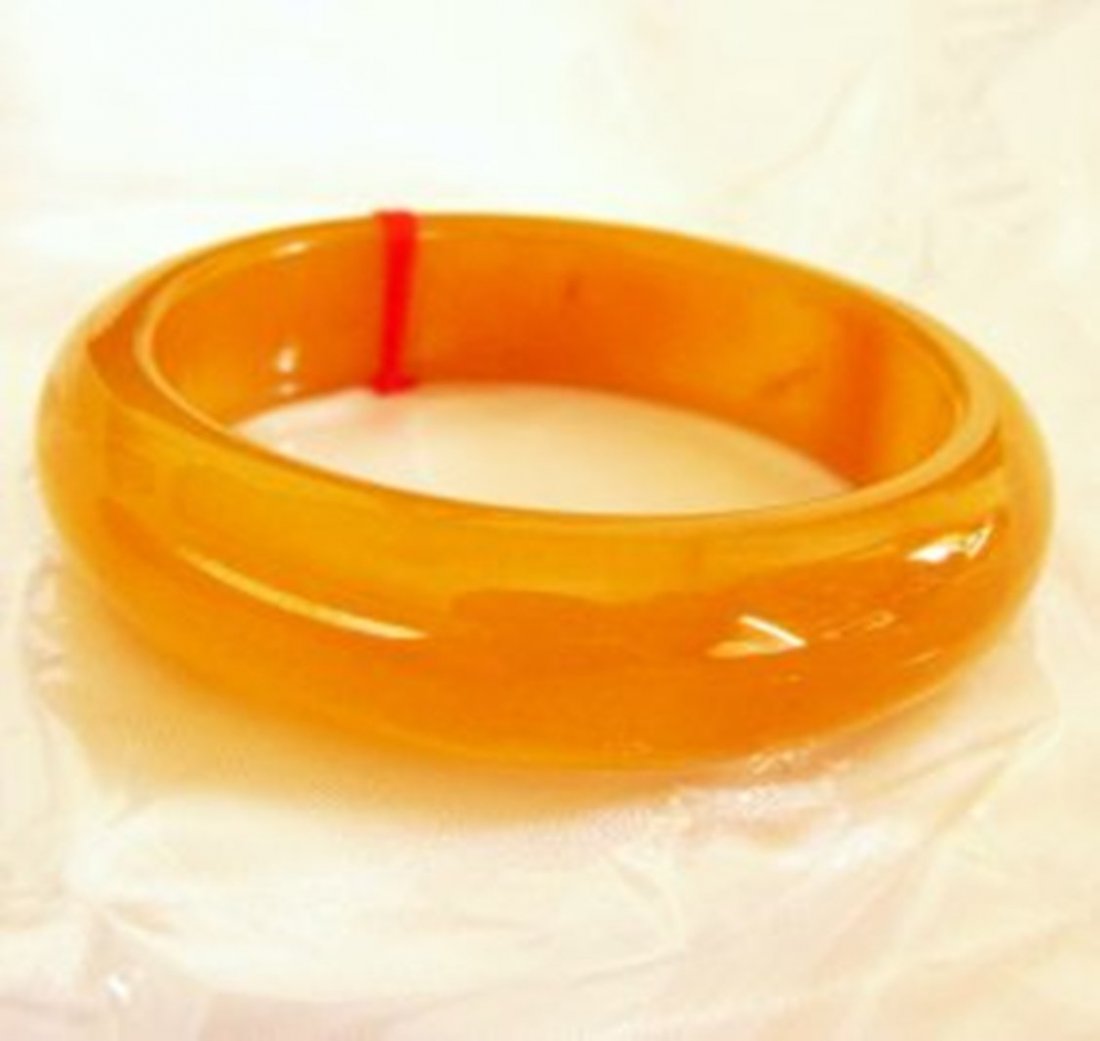 Natural Jadeite Jade Bangle JBA-2B/Size 7.5: Natural Jadeite Jade Bangle Clarity: JBA-2B, Color: Golden Transparency: Semi -Transparent Shape & Cut: Solid Jade Band Haft Round Jade Finish: High Polish Remarks: Genuine Jadeite Quality: Excellent 
