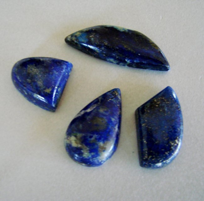 Natural Royal Blue Lapis Lazuli Lot 4Pcs/64.71Ct: Gem Type:Natural Royal Blue Lapis Lazuli Cabochon 4 Pieces Weight: 64.71 carat Cabochon Haft Oval,Pear,Marquise,Trillion Clarity: Opaque,Color:Royal Blue,Treatment:None Hardness:5.5 Measurement:32.2x1