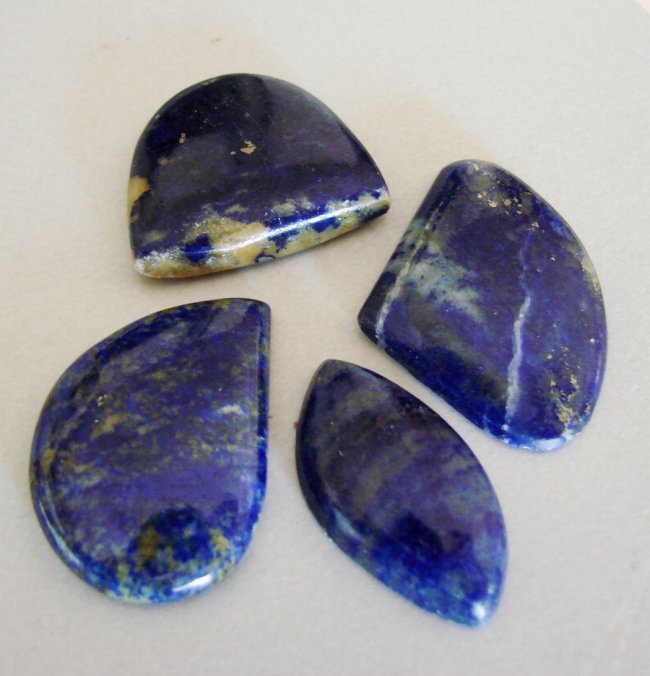 Natural Royal Blue Lapis Lazuli Lot 4Pcs/91.30Ct: Gem Type:Natural Royal Blue Lapis Lazuli Cabochon 4 Pieces Weight: 91.30 carat Cabochon Marquise,Pear,,Haft Oval Clarity: Opaque,Color:Royal Blue,Treatment:None Hardness:5.5 Measurement:30x20.3/30x23/