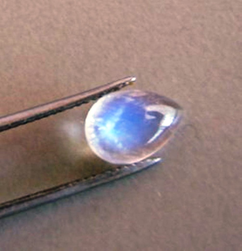 Blue White Rainbow Moonston Pear 1.67Ct 9.8x7x3.4mm: Gem: Natural Moonstone Qty: 1 Weight: 1.67 Carat Pear Shape Cut: Cabochon Measurement: 9.8 x 7x 3.4mm Clarity: Transparent Color: Blue White Rainbow Treatment: None Origin: Sri Lanka (Ceylon)