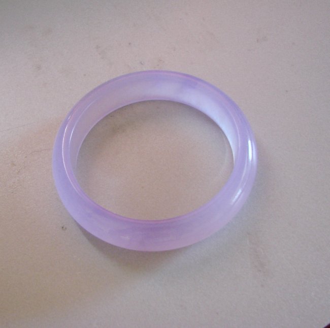 Natural Jadeite Jade Bangle JBA-B Size 7: Natural Jadeite Jade Bangle Clarity: JBA-B, Color: Lavender Transparency: Semi -Transparent Shape & Cut: Solid Jade Band Haft Round Jade Finish: High Polish Remarks: Genuine Jadeite Quality: Excellent