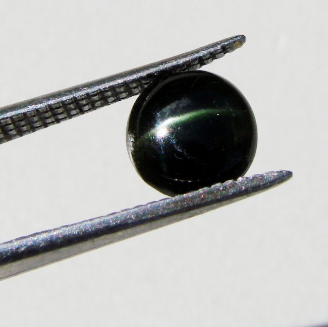 Grayish Brown Sillimanite Cat's Eye Cabochon 3.24Ct: Gem:Natural Sillimanite Cat's Eye Quality: 1 Piece Measurement: 9.5x3.7 mm Weight: 3.24 Carat Shape Round Cabochon Clarity: Opaque ,Color: Grayish Brown Treatment: None Origin: Madagascar Estimate Val