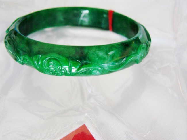 Natural Jade Carved Ruyi Imperial Bangle Grade A: Jade Type: Natural Maw-Sit-Sit Carved Jade Qty: 1 Item: Carved Jade Bangle Grade: A Clarity: Deep Polish, Translucent, Color: Deep Imperial Green/Black Spot Luster: Excellent Origin: Burma Out