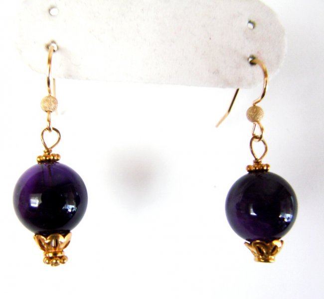 Natural Amethyst Drop Earrings 28.40Ct 18k Y/g Filled: Gem: Natural Amethyt Bead Item: Earrings Weight:28.40 Carat Round Shape Measurement: 12 mm Clarity: SI-Color: Purple Length:1.1/2"x Width: 1/2" 18k Yellow gold Filled Weight: 1.60 grams Gender: