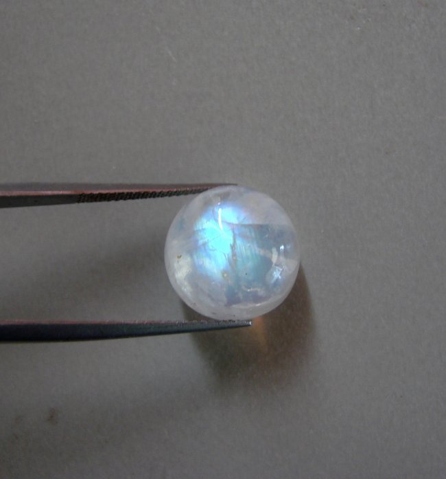 Blue White Rainbow Moonston Round 11.98Ct 14x7.8 mm: Gem: Natural Moonstone Qty: 1 Weight: 11.98 Carat Shape: Round Cut: Cabochon Measurement: 14x7.8 mm Clarity: Transparent Color: Blue White Rainbow Treatment: None Origin: Sri Lanka (Ceylo