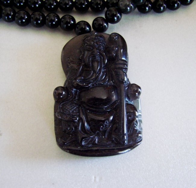 Necklace Caved Land Lord Buddhist Onyx 56.45 gram: Gem Type: Natural Black Onyx Necklace and Pendant Caved Land Lord Buddhist Weight: 56.45 gram Clarity: Opaque , Color: Black and Golden Pendant Size L 1.7/8" x W 1.1/4" inch Bead Size 6.5 mm Length Ne