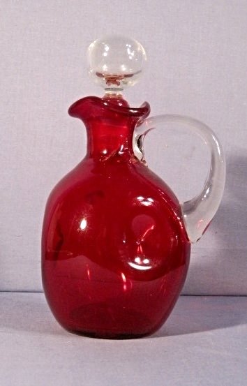 MID CENTURY BLENKO RUBY GLASS PINCH TRICORN DECANTER XR: We are pleased to offer this vintage 1950s era Blenko Ruby Red Glass Decanter. This is a classic pinch shaped bottle with a tricorn rim. It features a crystal applied handle and a crystal ball stopper