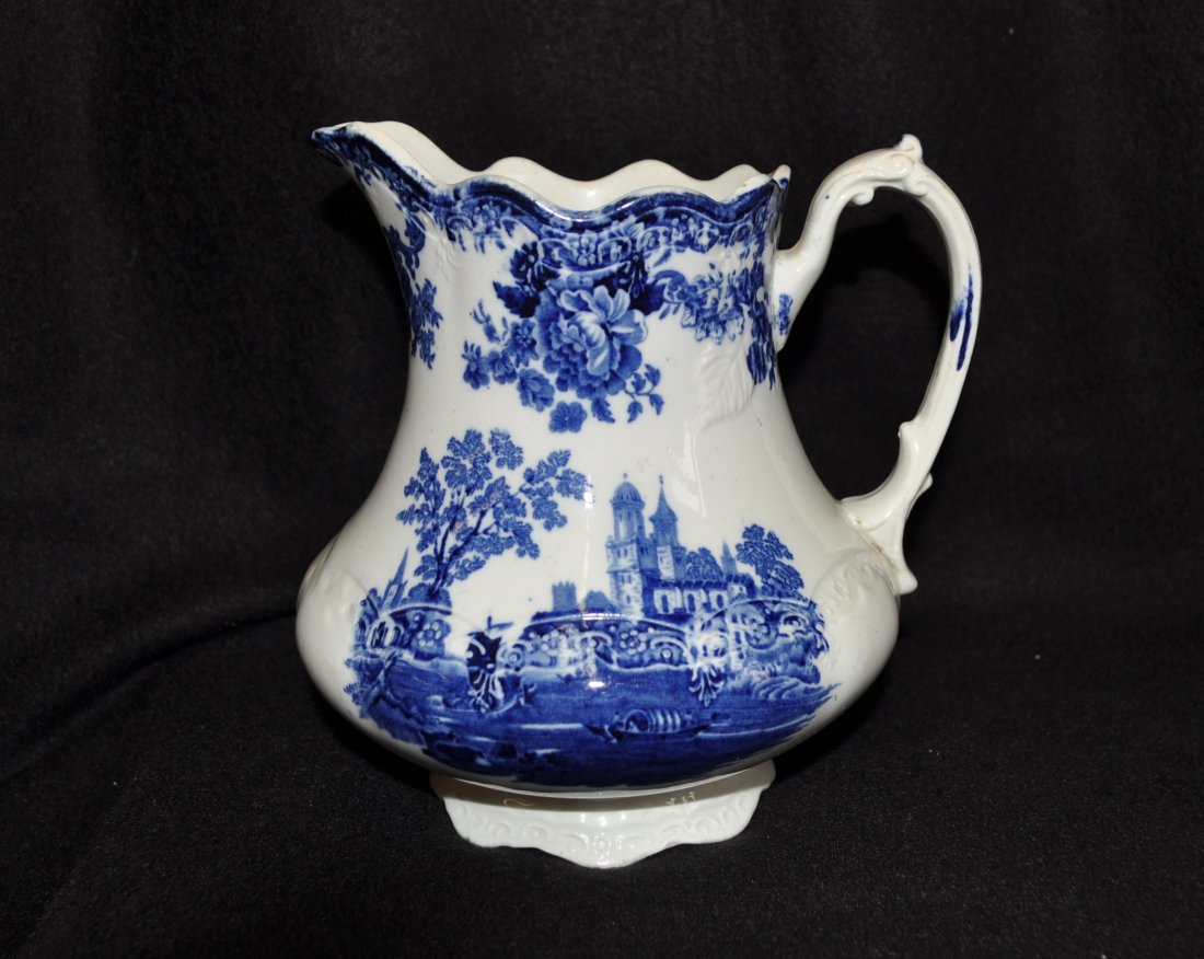 FW WINKLE 1910-20 COLONIAL POTTERY FLOW BLUE PITCHER XT: We are proud to showcase this classic English antique early 1900s semi porcelain Romantic Staffordshire Flow Blue Transfer Ware milk pitcher in the majestic, rich Cobalt and highly detailed scenic & f