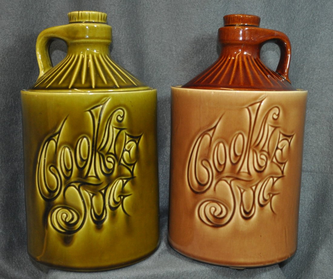 VINTAGE MCCOY COOKIE JUG JARS 2 PCS GREEN BROWN XT: Here we have a pair of McCoy Cookie Jugs/Jars for your bidding consideration. These Cookie Jars are in the shape of Jugs. One is finished in Green and one in Brown. They measure 11.25" tall and are 6.