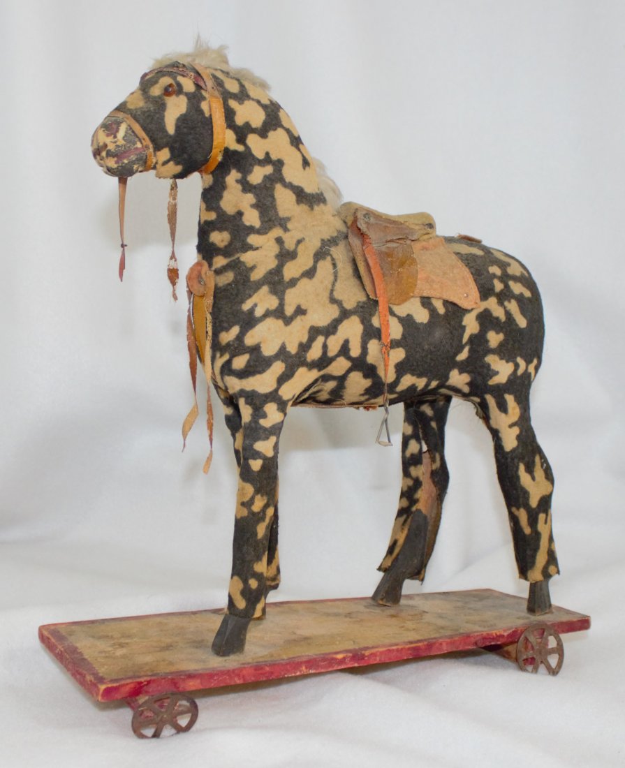 1950s SADDLED HORSE PULL TOY JC: Offered for your consideration this Saddled Horse Pull Toy , unusual colors , plastic body covered with fabric , wooden legs fabric covered , 12 inches , Base has hand written "57 Clarence", circa 195
