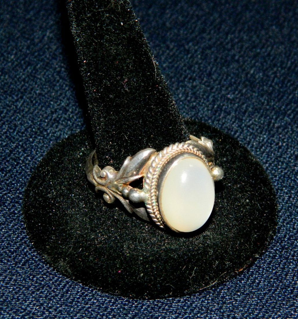 925 STERLING SILVER MOONSTONE LADIES RING XR: We are happy to offer this contemporary Ladies Sterling Silver size 11 Moonstone Ring. This 12 gram ring offers a round cabochon Moonstone framed in sterling silver with a decorative cutout design on