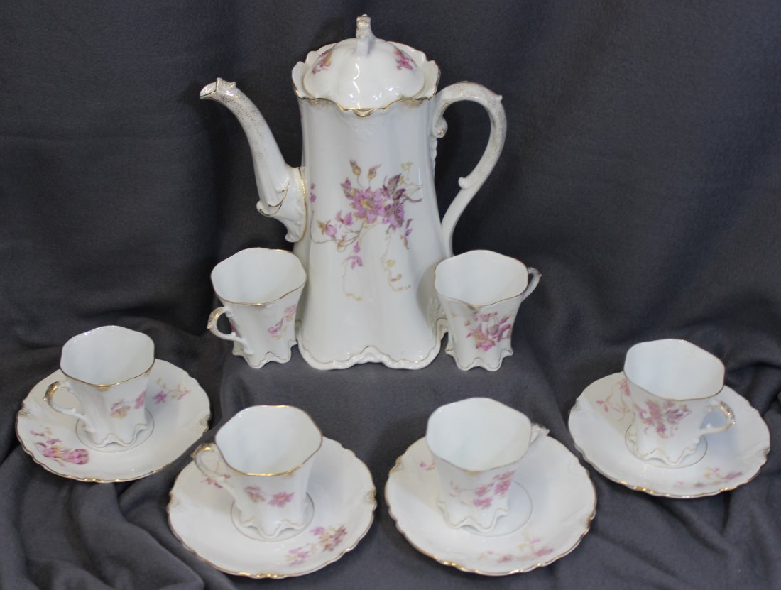 1920s HERMANN OHME HP 11 PC PORCELAIN CHOCOLATE SET XW: pot measures: 9x6.25x10; cups measures: 3.5x2.75x2.75; saucers measures: 5.75x5.75x.75We are very pleased to offer this 1920s porcelain hand painted floral chocolate set by Hermann Ohme of Niedersalzb