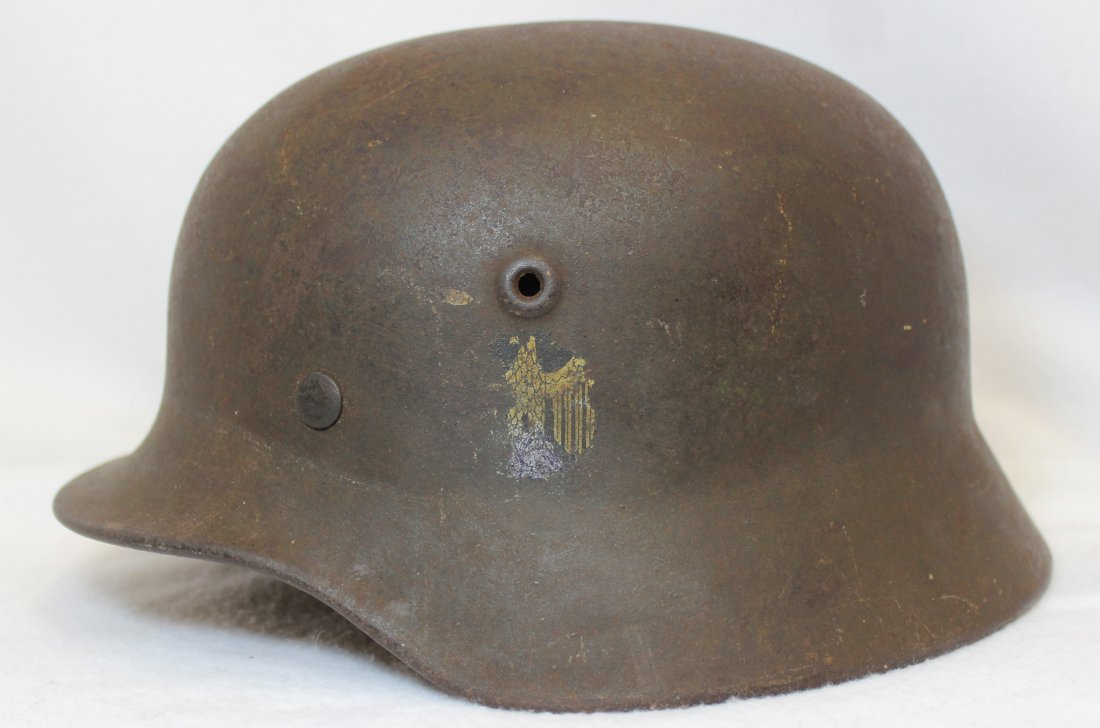 WORLD WAR II NAZI GERMAN MILITARY HELMET XW: We are pleased to present this German WW II helmet, belonging to the Army (Heer) The pot appears to be the 1935 pattern, which was used from 1938-1945. Our helmet weighs 3# 6 oz. and measures 11.25 x 