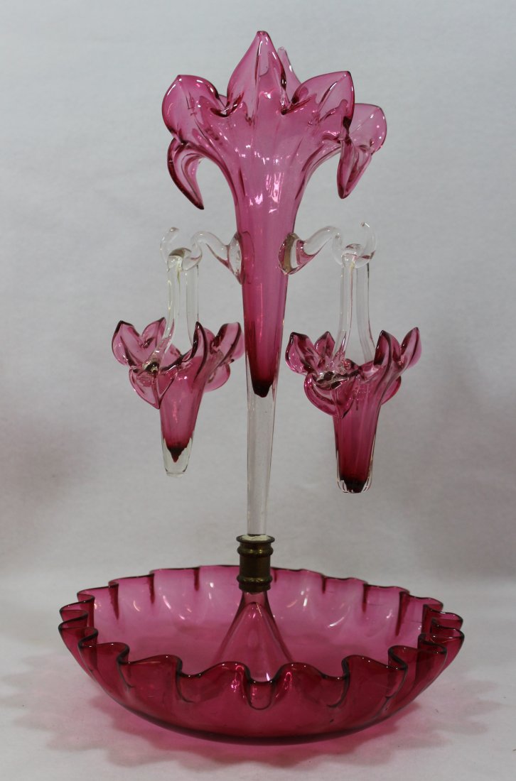 ENGLISH EDWARDIAN CRANBERRY HB FLEUR DE LIS EPERGNE X?: We are exceptionally proud to present this single center trumpet + 2 hanging baskets, hand blown English Cranberry epergne from the period 1915-1925. Our example is a compact table epergne in a fancif