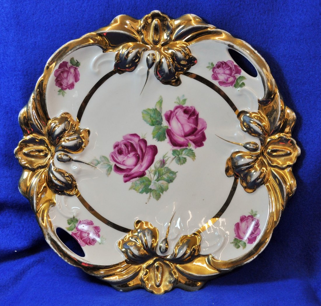 1950 GERMAN PORCELAIN HP IRIS HANDLE MOLD CAKE PLATE XW: Weight: 1# 4 oz. *** Measurements: 10 x 10 x 1.25 ***The AEAA is very pleased to offer this gorgeous 1950s German heavily gilded masterful Iris molded & dual handled cake plate, with lovely maroon tea