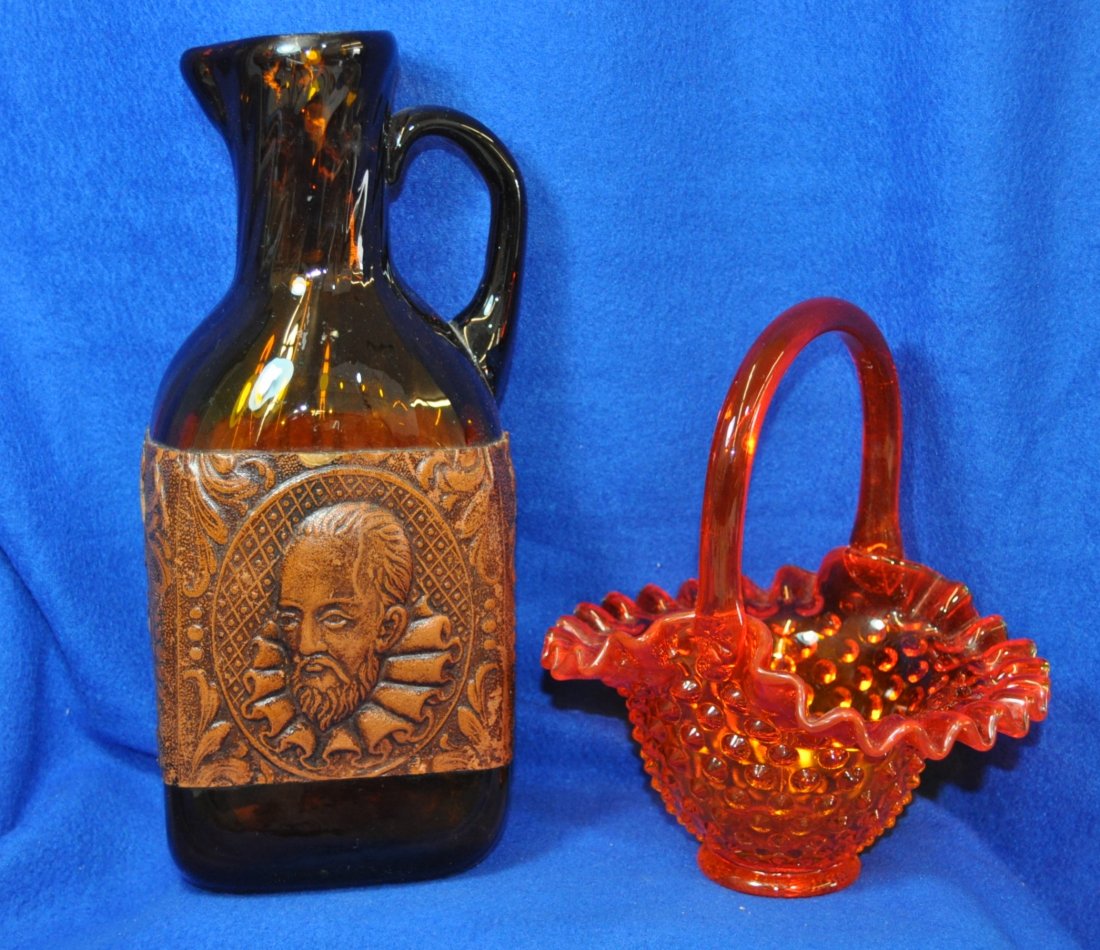 FENTON HOBNAIL BASKET AND TOOLED LEATHER HB BOTTLE XW: Here we have a 1960s Fenton Hobnail Basket and a Hand Blown Tooled Leather Banded Shakespeare Pitcher for your bidding consideration. The 1960s Fenton Hobnail Basket is orange hobnail #3837-OR. It can