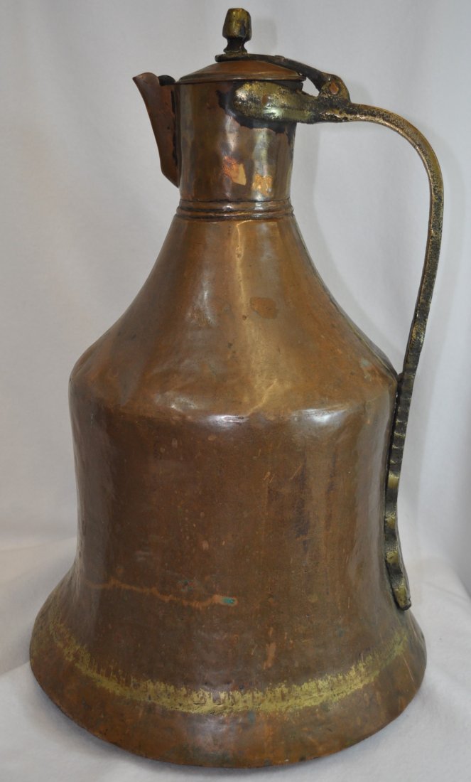 GIANT HD HAMMERED COPPER BRASS HANDLE WINE PITCHER XT: We are very pleased to present this mammoth 13 x 13 x 20.5 inch tall hand hammered Indian copper pitcher, with a lattice accented brass handle (and joiner work) from the 1960s-1970s. The weight of thi